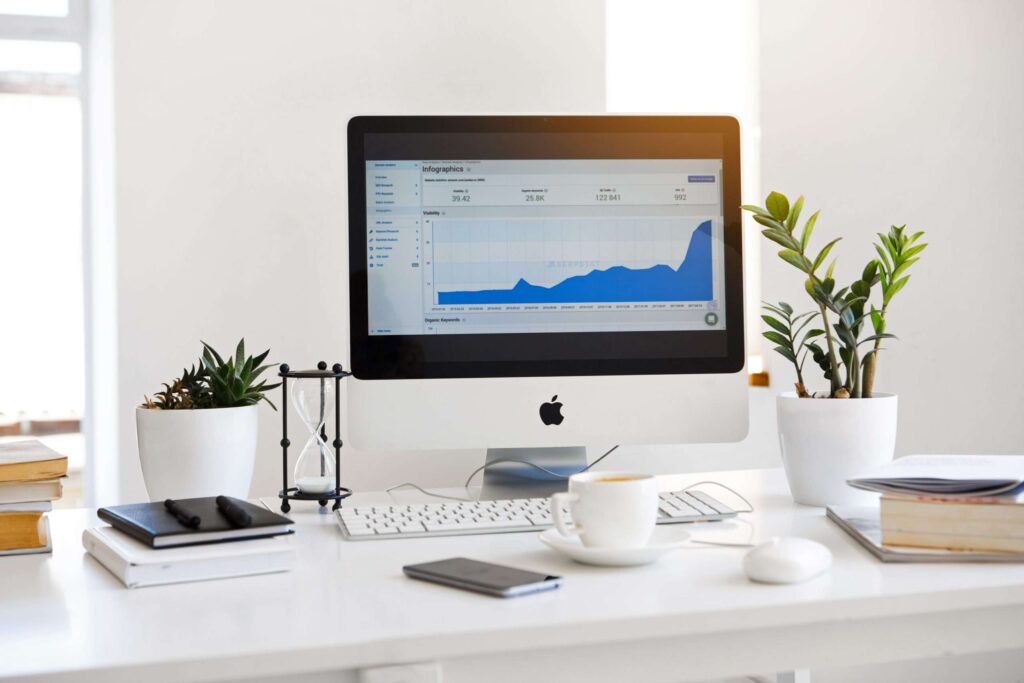 Mac showing line graph on a tidy desk