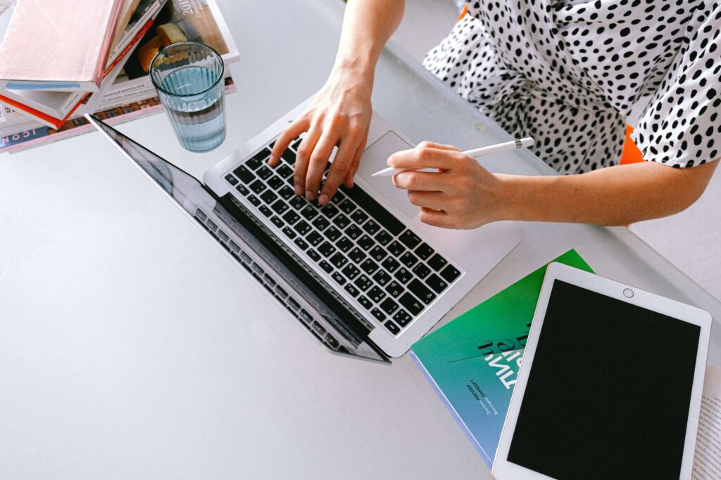 top down view of person working at a macbook pro laptop