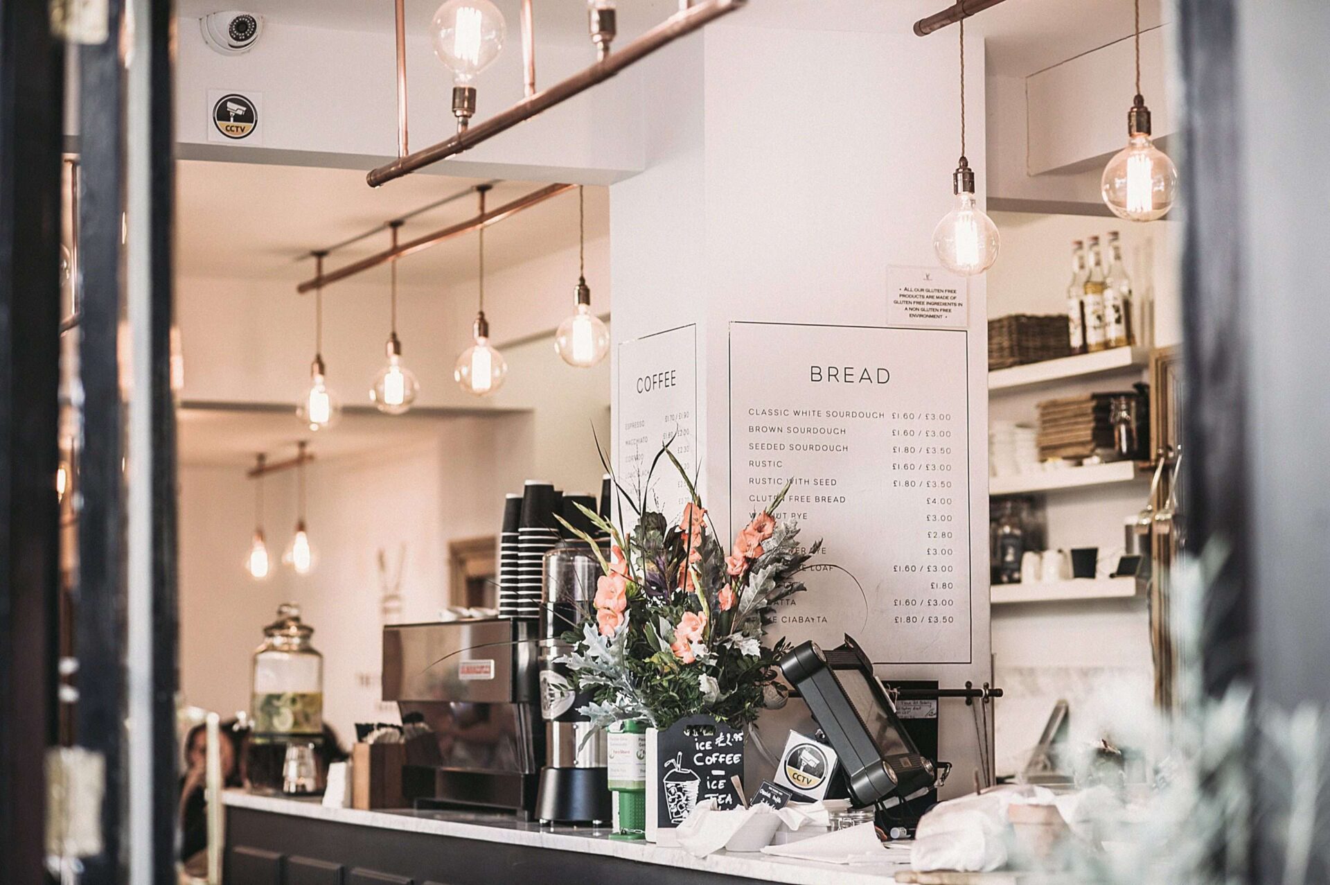 Interior of cafe restaurant showing counter with menu on wall and