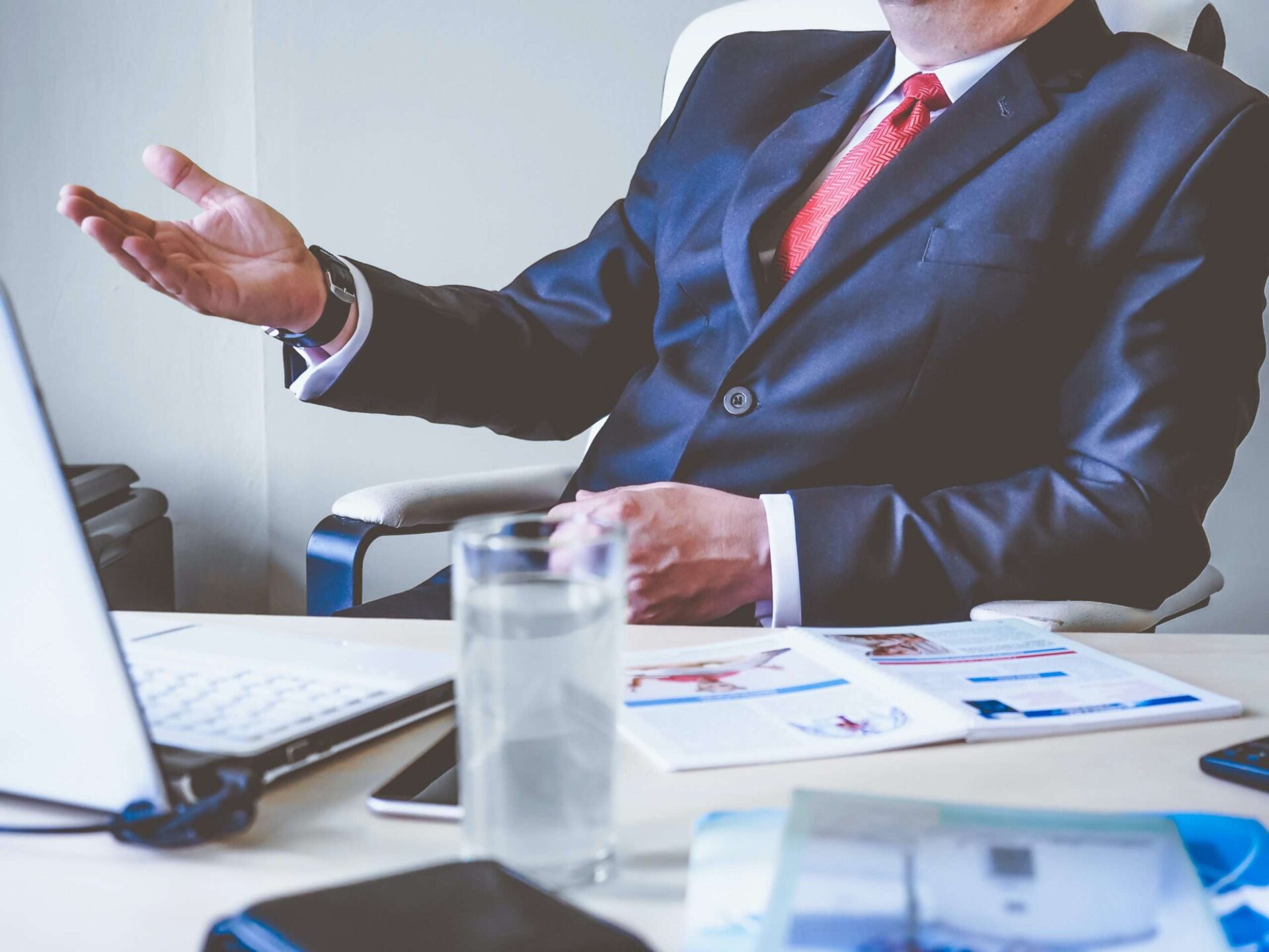 business man in blue suit on a video call through his laptop