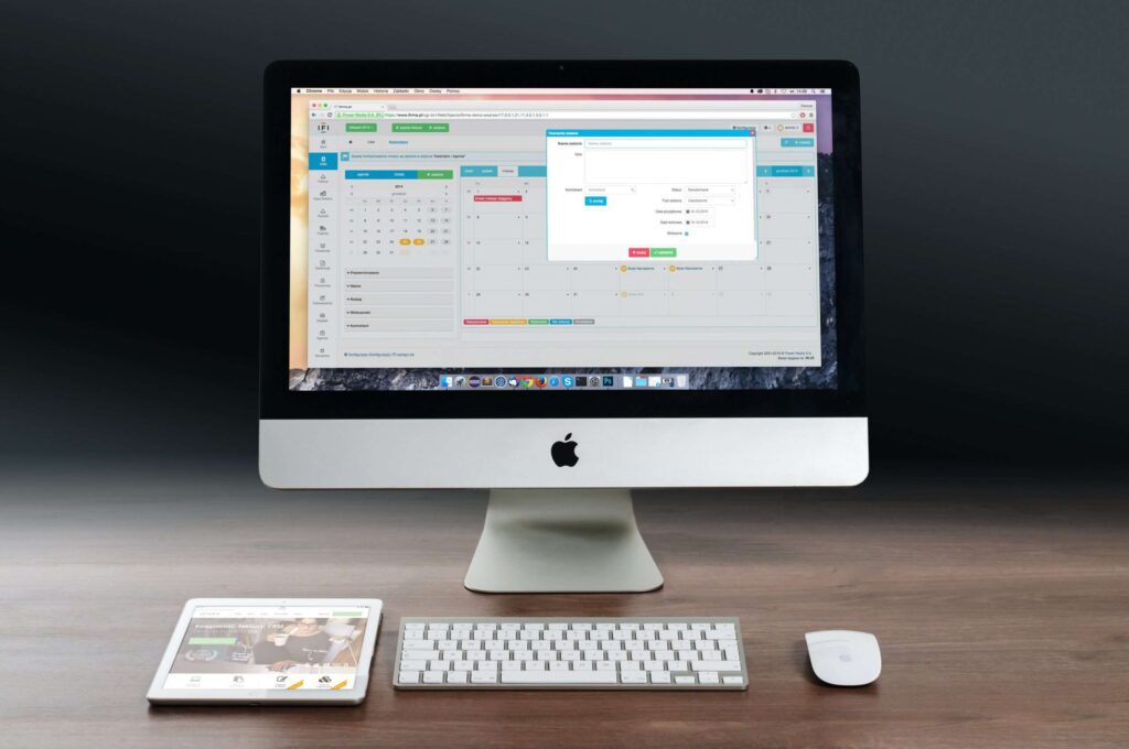 Mac computer on an empty desk showing software running