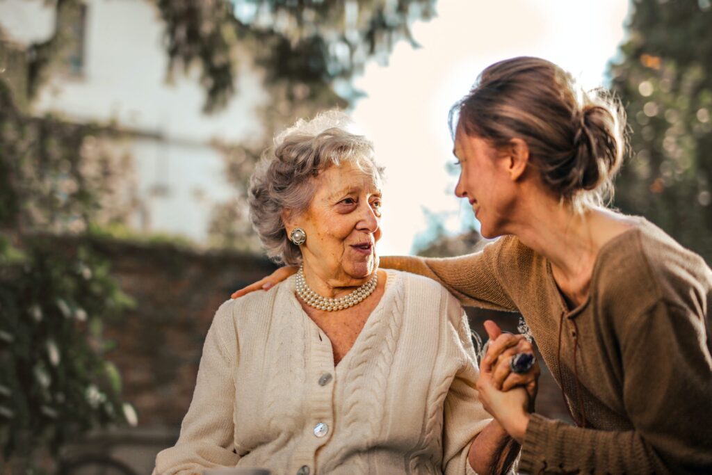 Smiling Care home worker talking to a resident of a care home