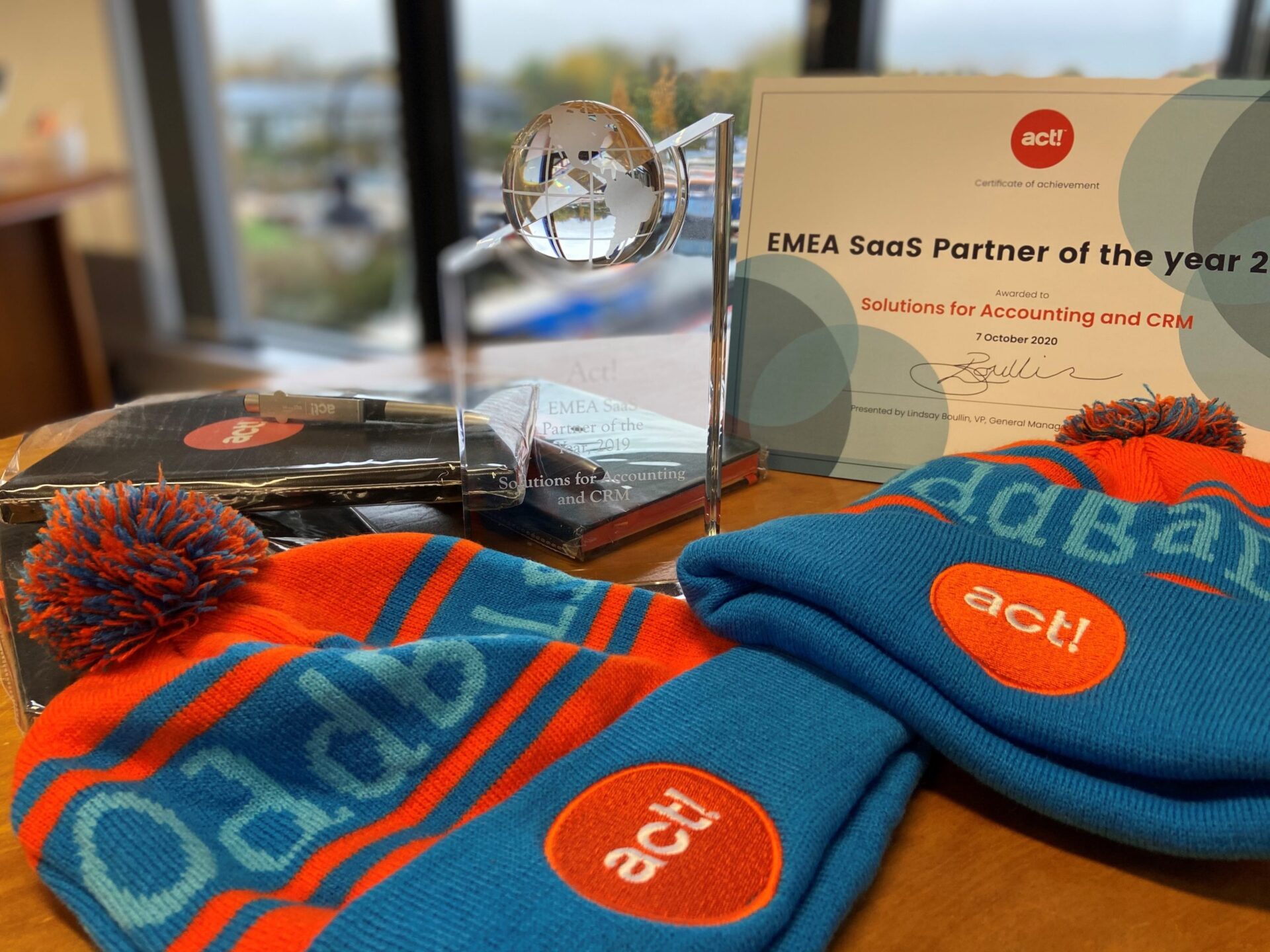 Closeup of Act CRM merch with an award of SaaS partner of the year