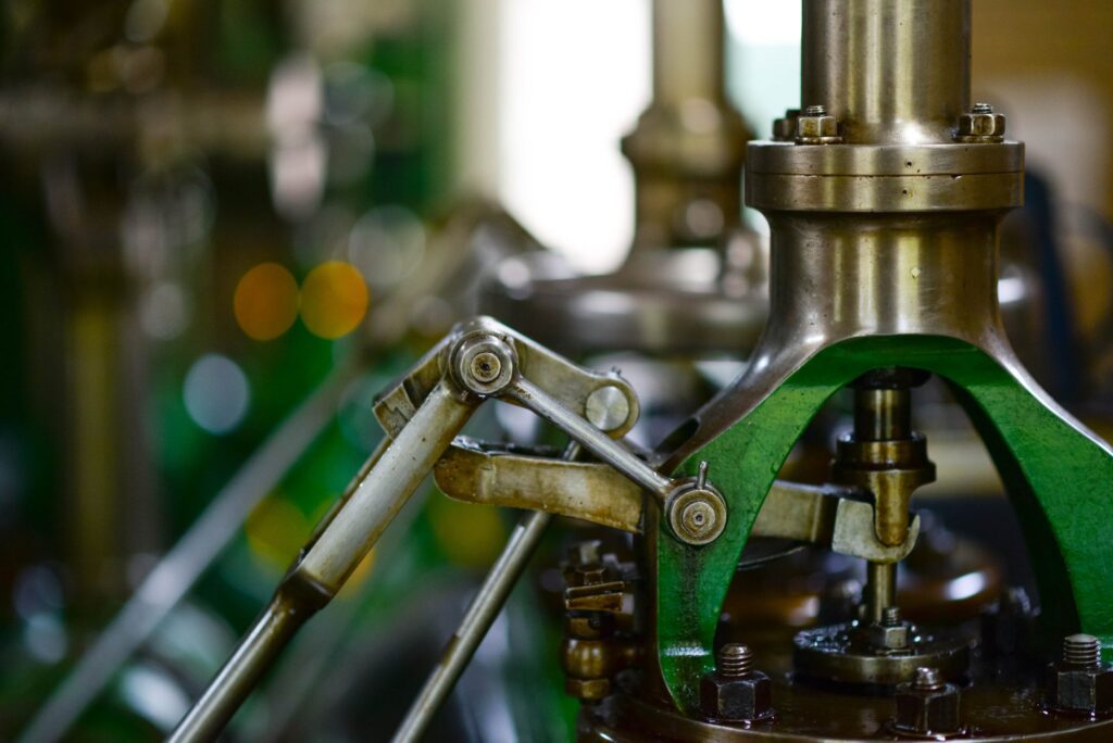 Extreme closeup photo of some machinery in a factory with background out of focus