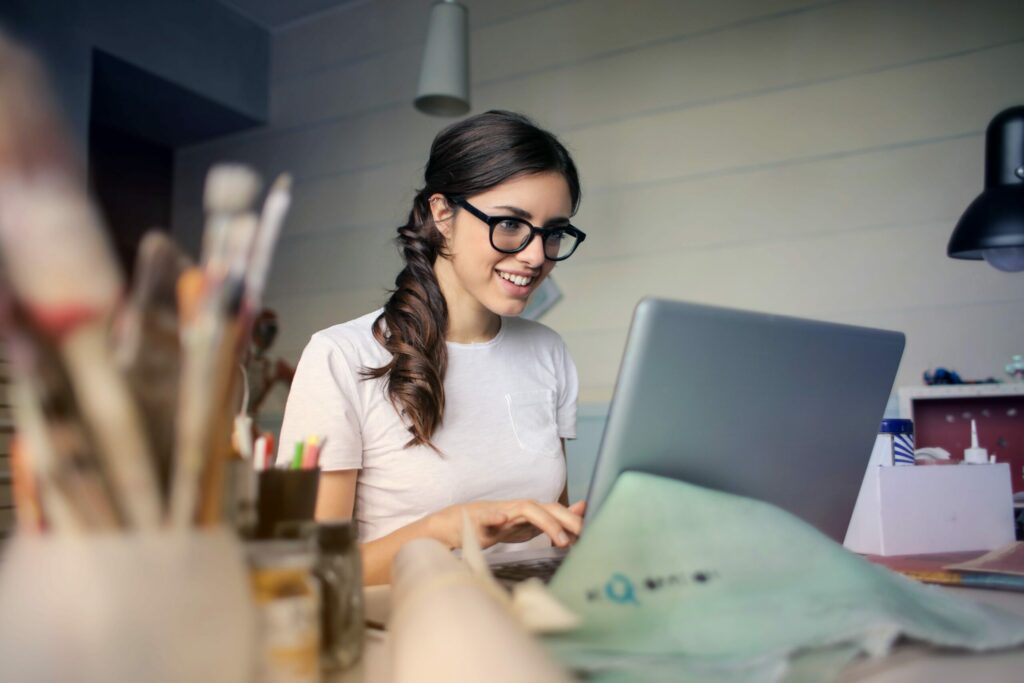 Woman working on a laptop in an art studio