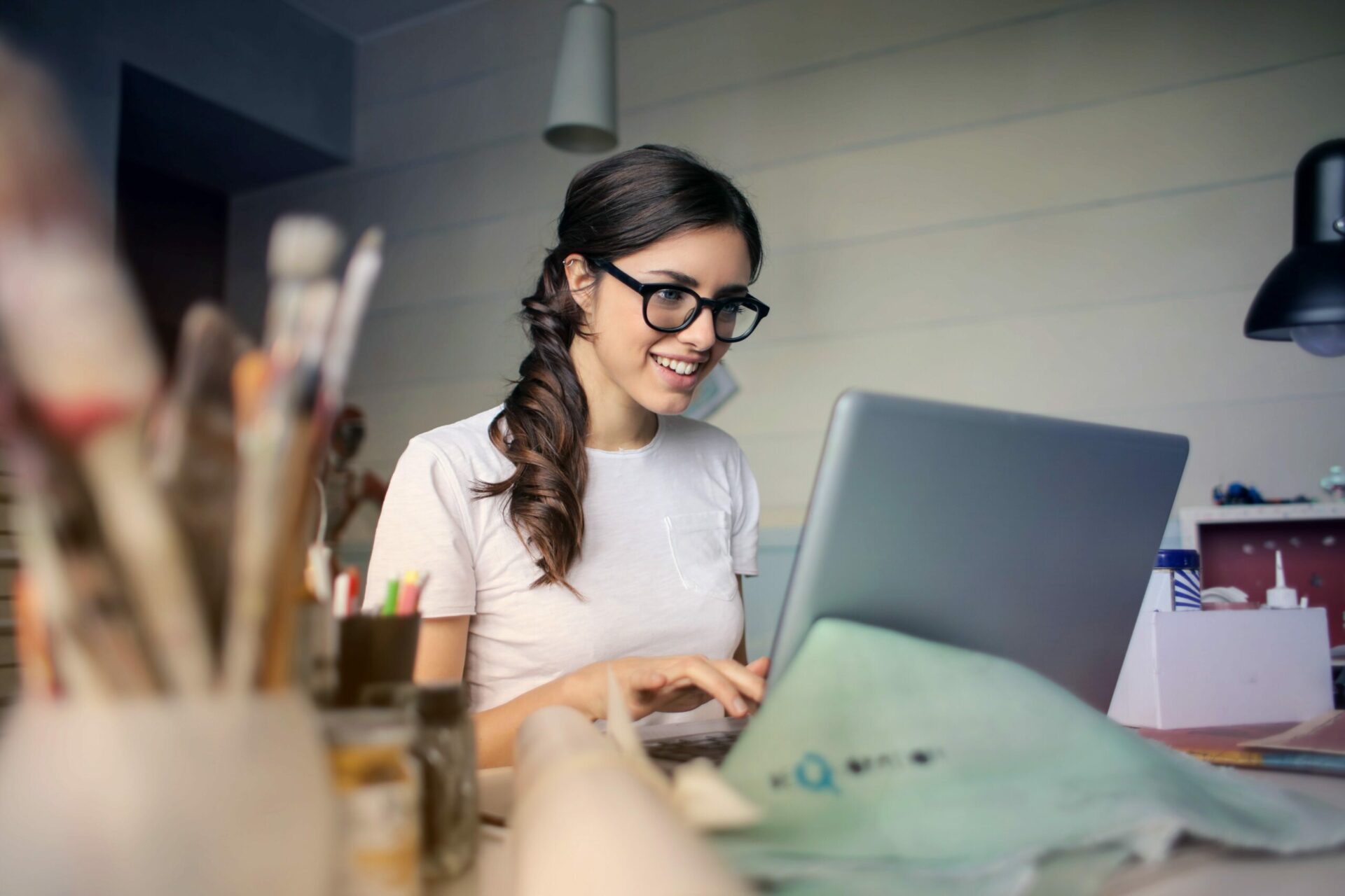Woman working on a laptop in an art studio