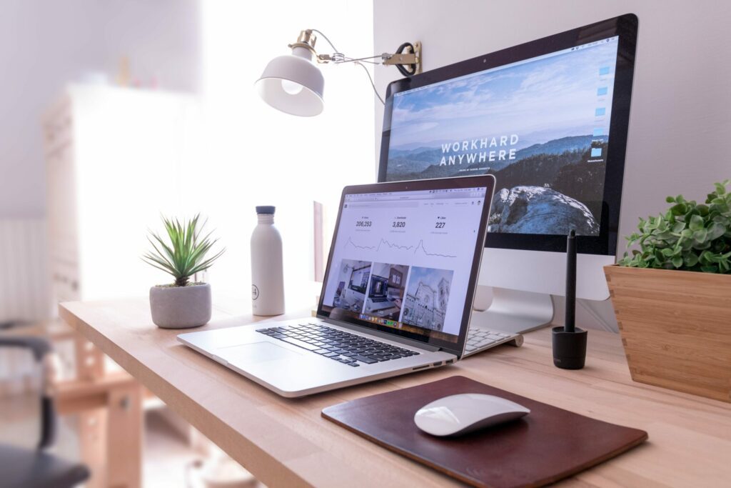 Working from home desk setup with a computer and laptop