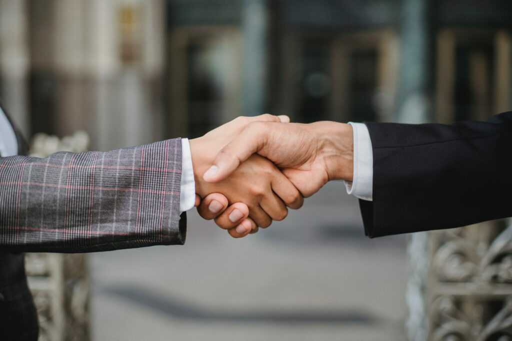 Closeup of a handshake between two people wearing suits