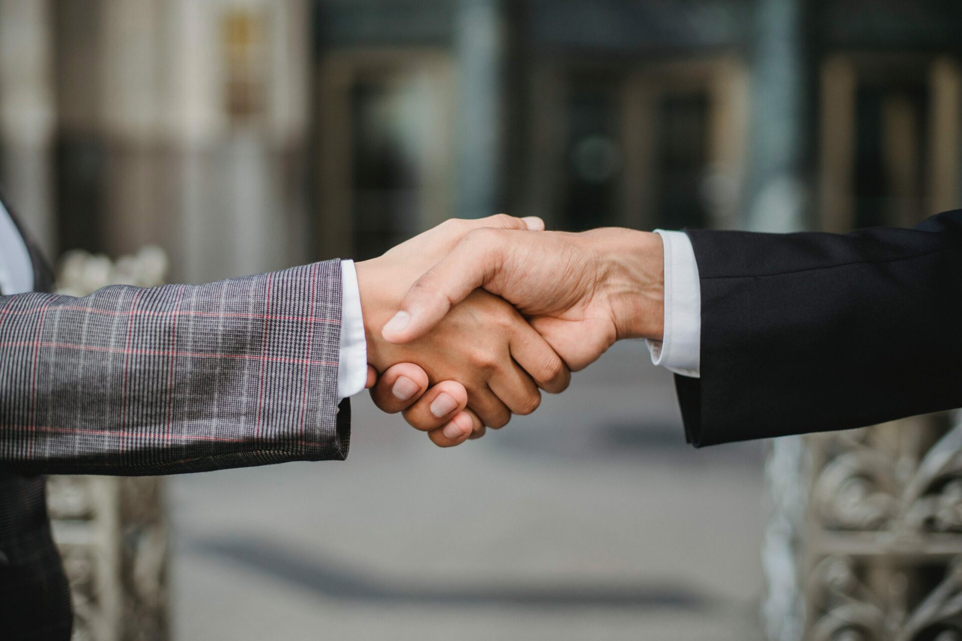 Closeup of a handshake between two people wearing suits