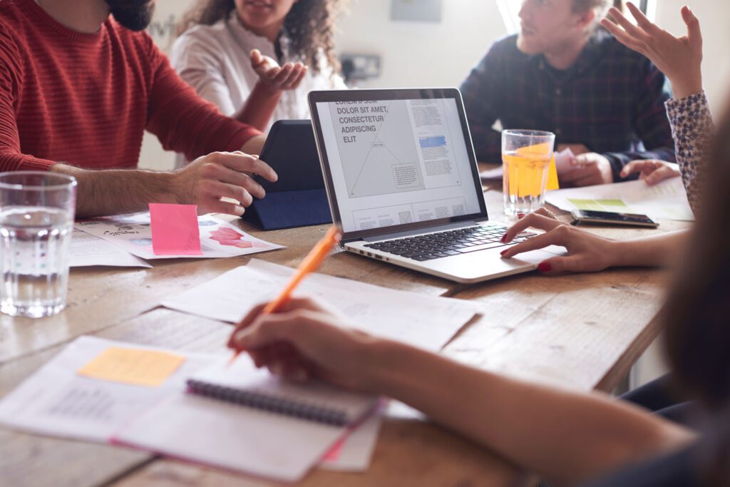 Designers Sitting on a Sofa Having Creative Meeting In Office