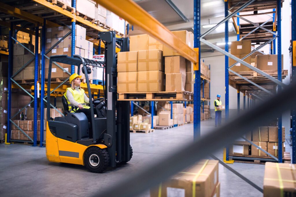 Woman driving a forklift inside a warehouse