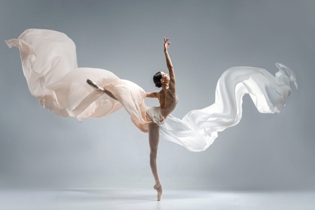 Ballet dancer performing while wearing a long flowing costume