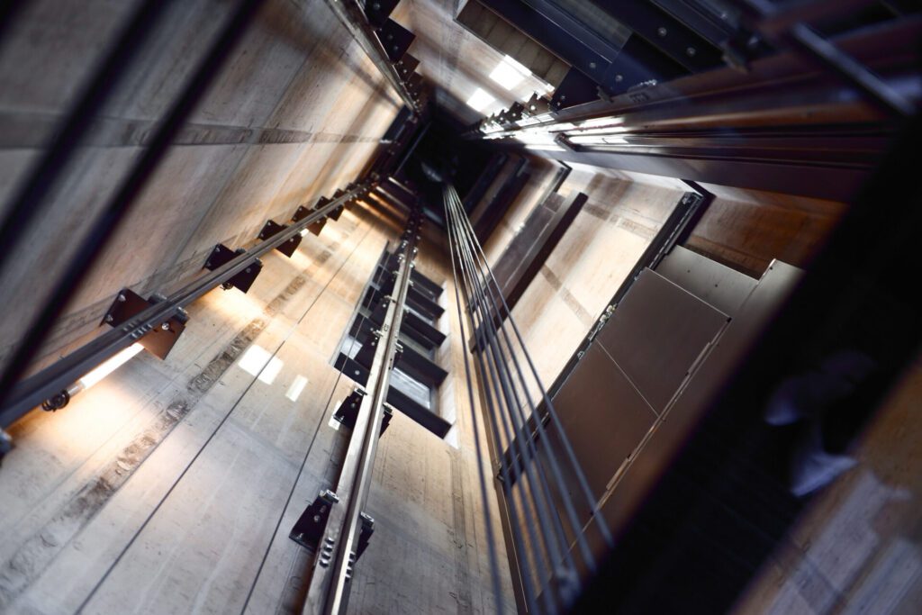 Dutch angle looking straight up in an elevator shaft