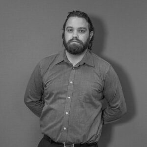 Solutions employee Sam Looms black and white profile photo
