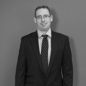 Solutions employee Sean Graham black and white profile photo