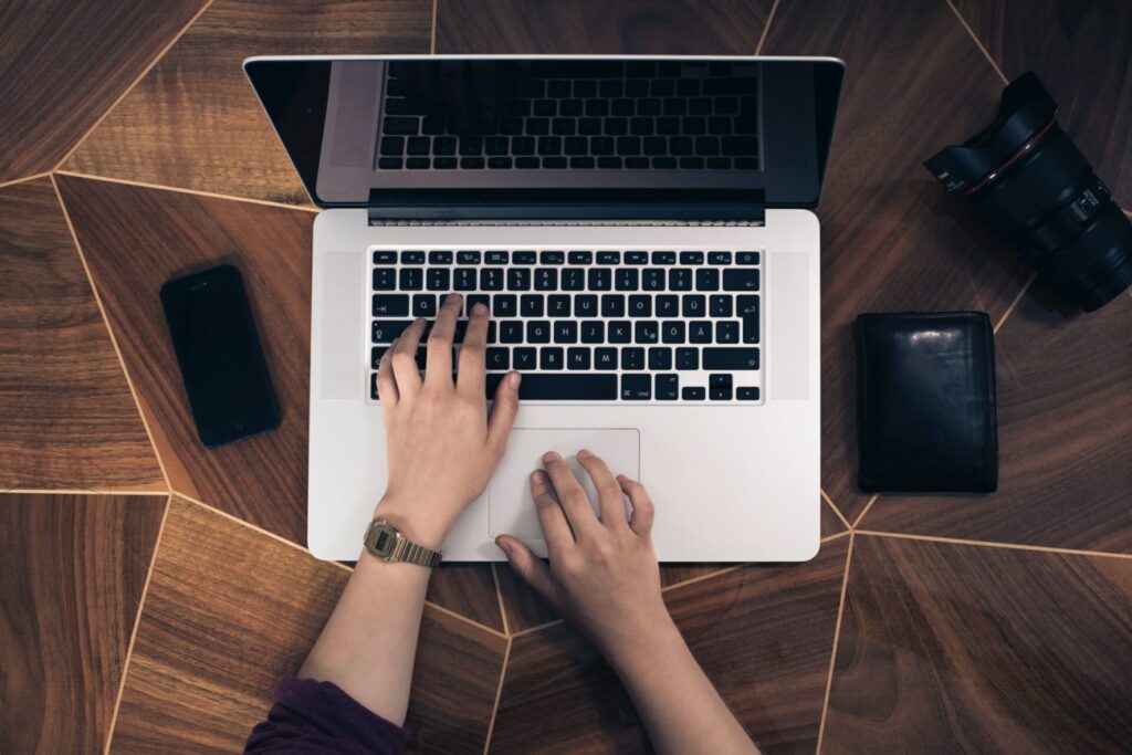 Top down view of a person typing on a laptop taken by Fabian Irsara