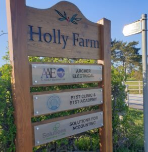 Sign outside of Holly Farm showing a sign for Solutions for Accounting