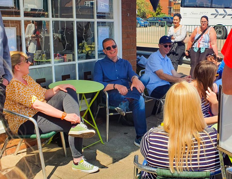 Solutions staff enjoying the sunshine outside a coffee shop