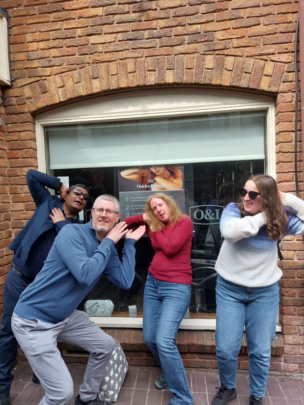Solutions employees posing by a hairdressers as part of a scavenger hunt