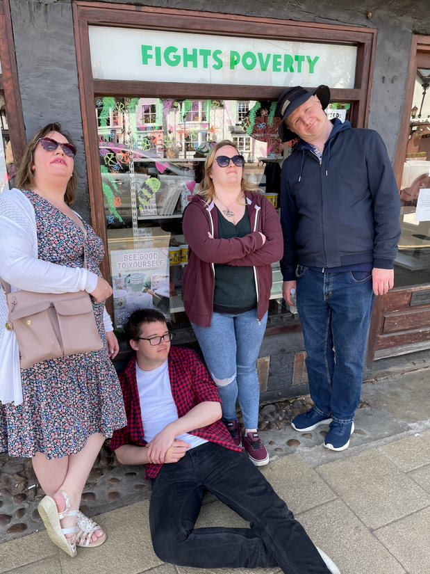 Solutions employees posing by a shop as part of a scavenger hunt
