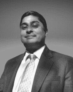 Solutions employee Kamlesh Ramji black and white profile photo