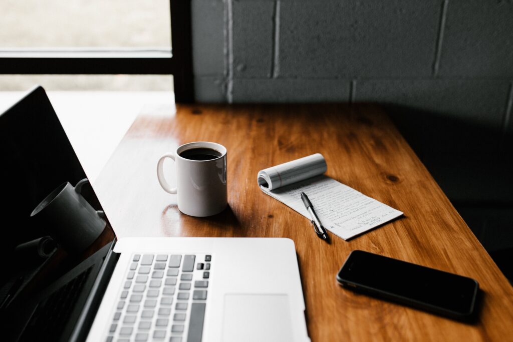 Clean desk with a laptop and coffee mug on