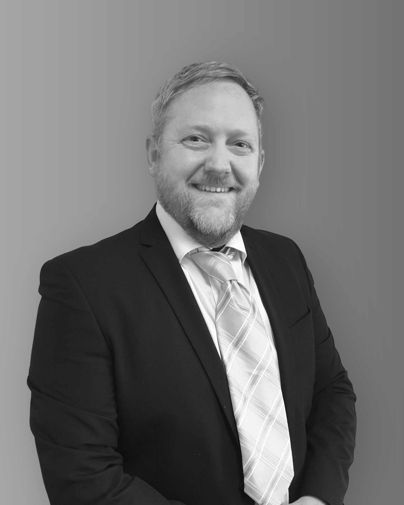Solutions employee Ben Haughie black and white profile photo