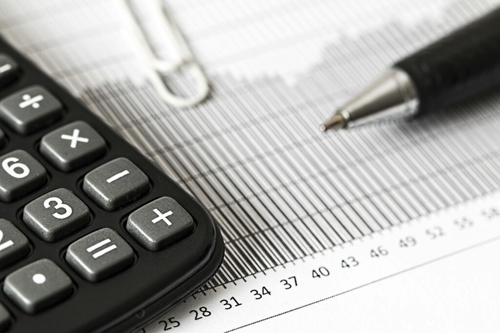 Closeup of a pen and a calculator on paperwork