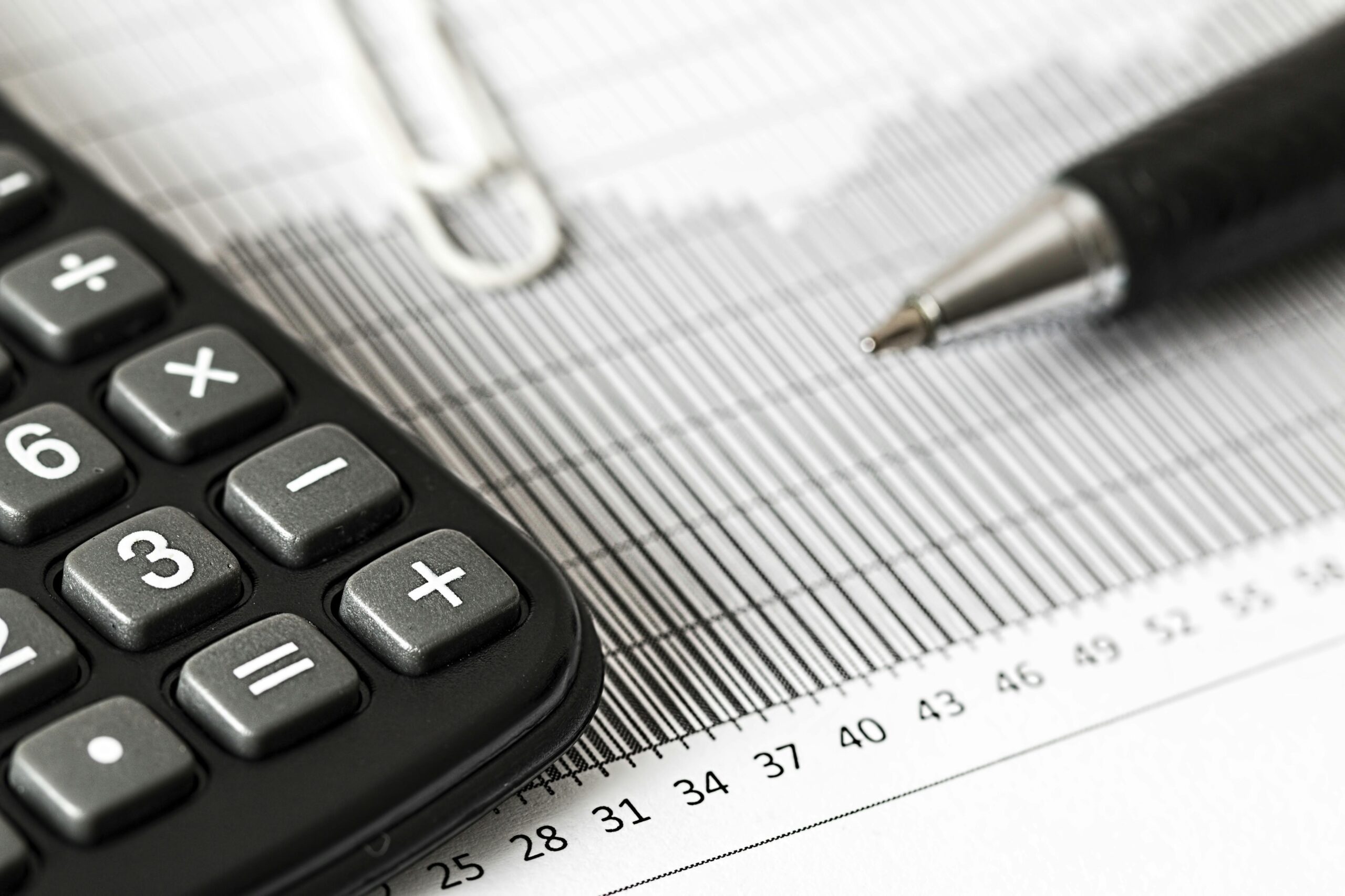 Closeup of a pen and a calculator on paperwork