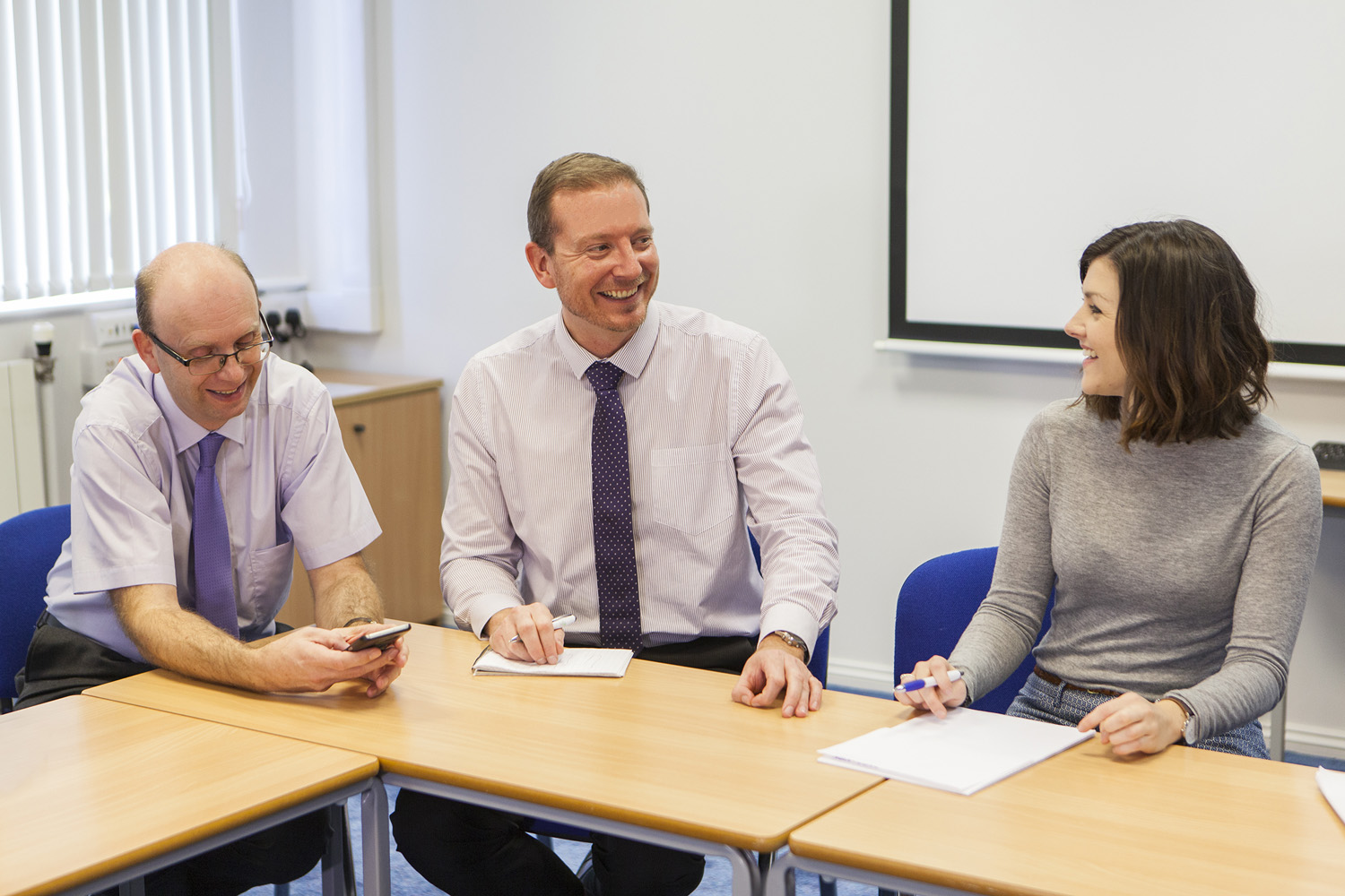 Three Solutions for Accounting staff meeting around a table