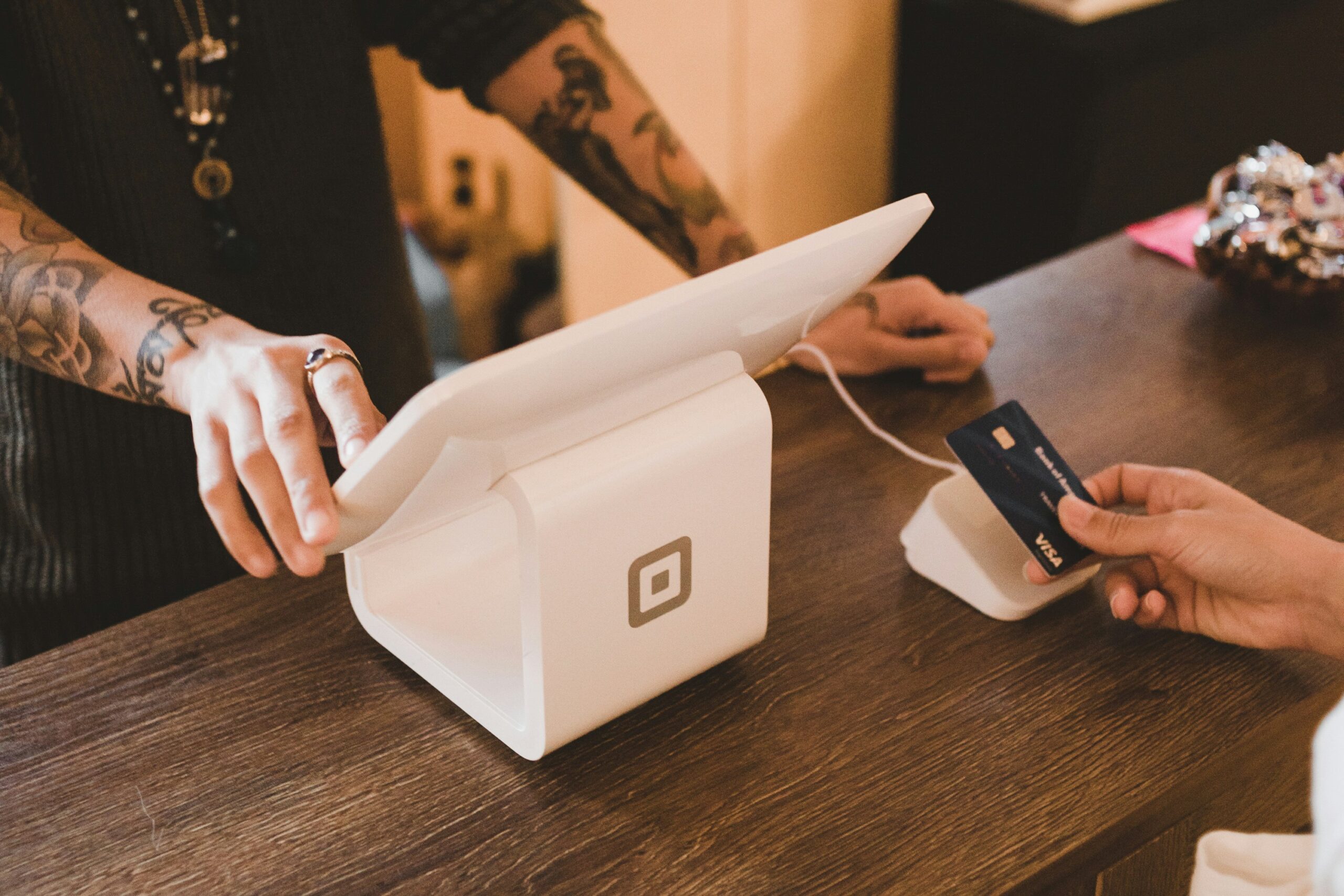 Person paying by card at checkout of a retail business