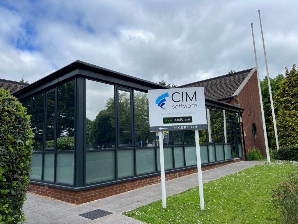 Outside of CIM Rebranded Office with sign and arrow pointing to reception
