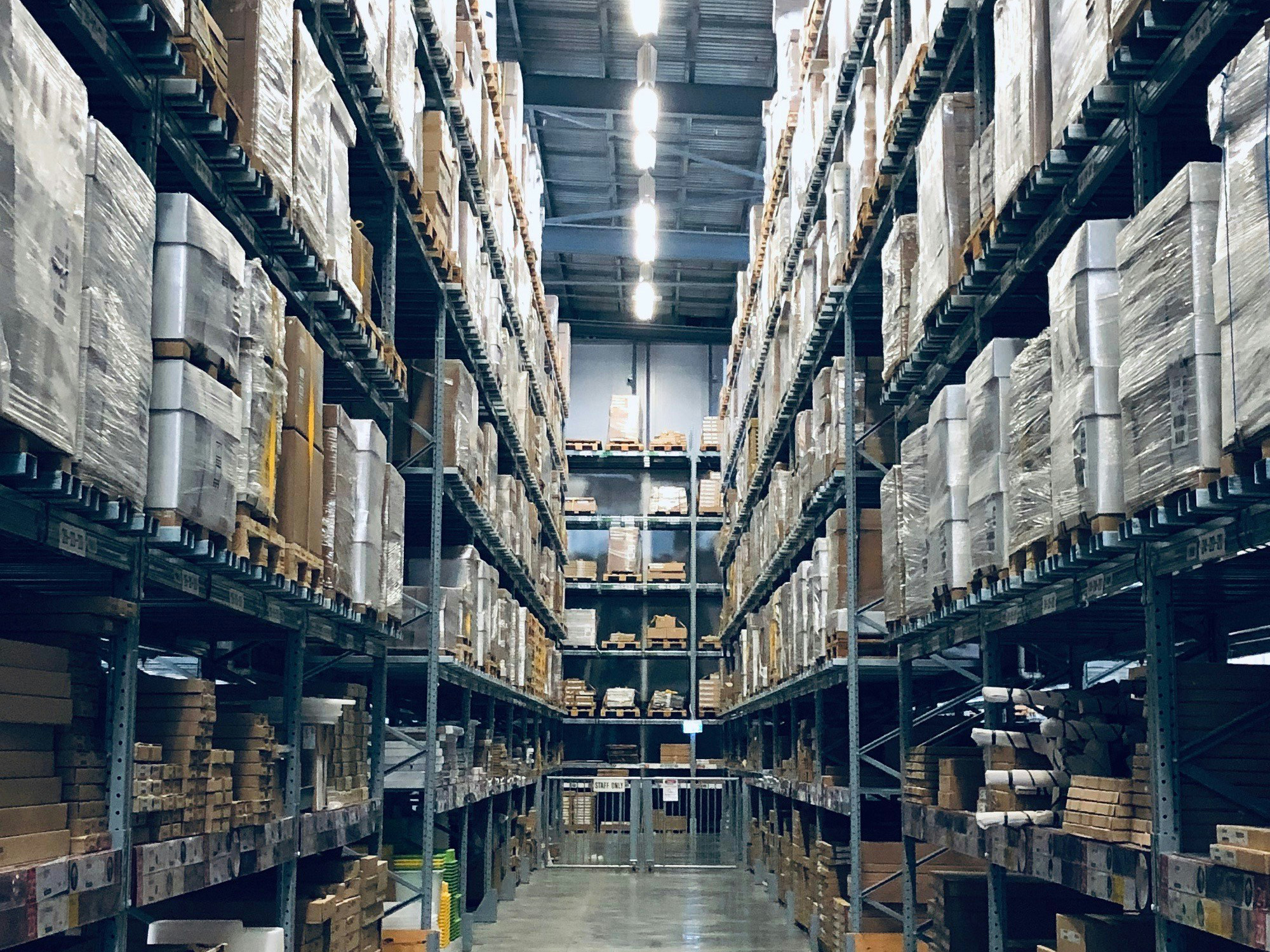 Large warehouse with shelves filled with boxes and pallets