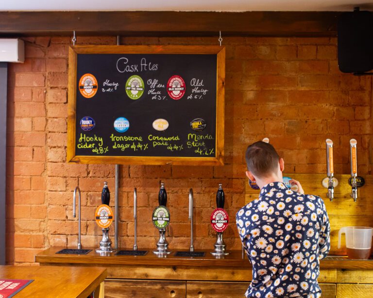Employee from Hook Norton brewery serving beer