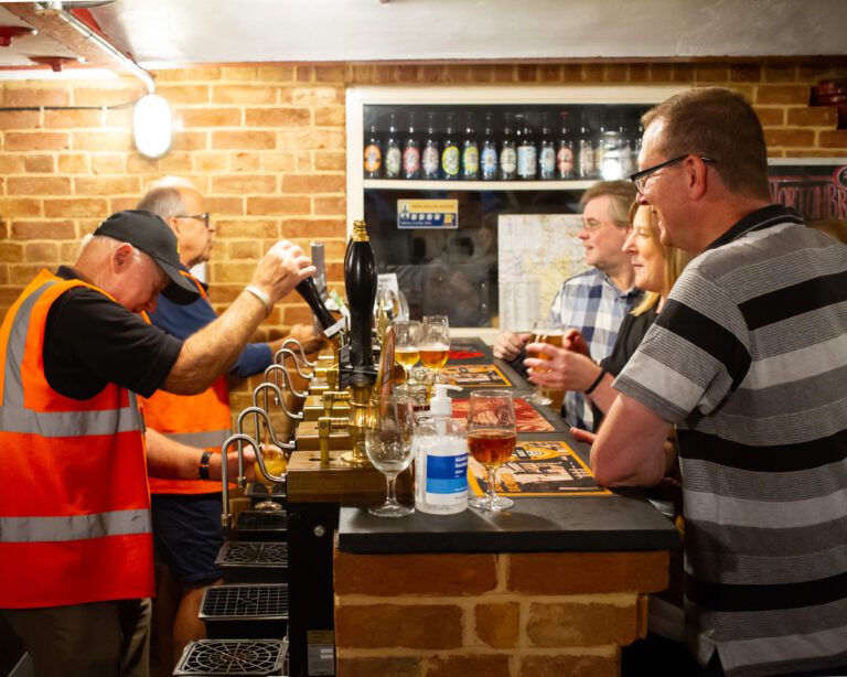 Solutions staff being served in a mock up pub inside a brewery