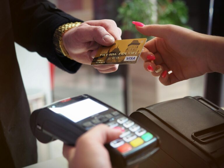 person paying at a checkout with a debit card