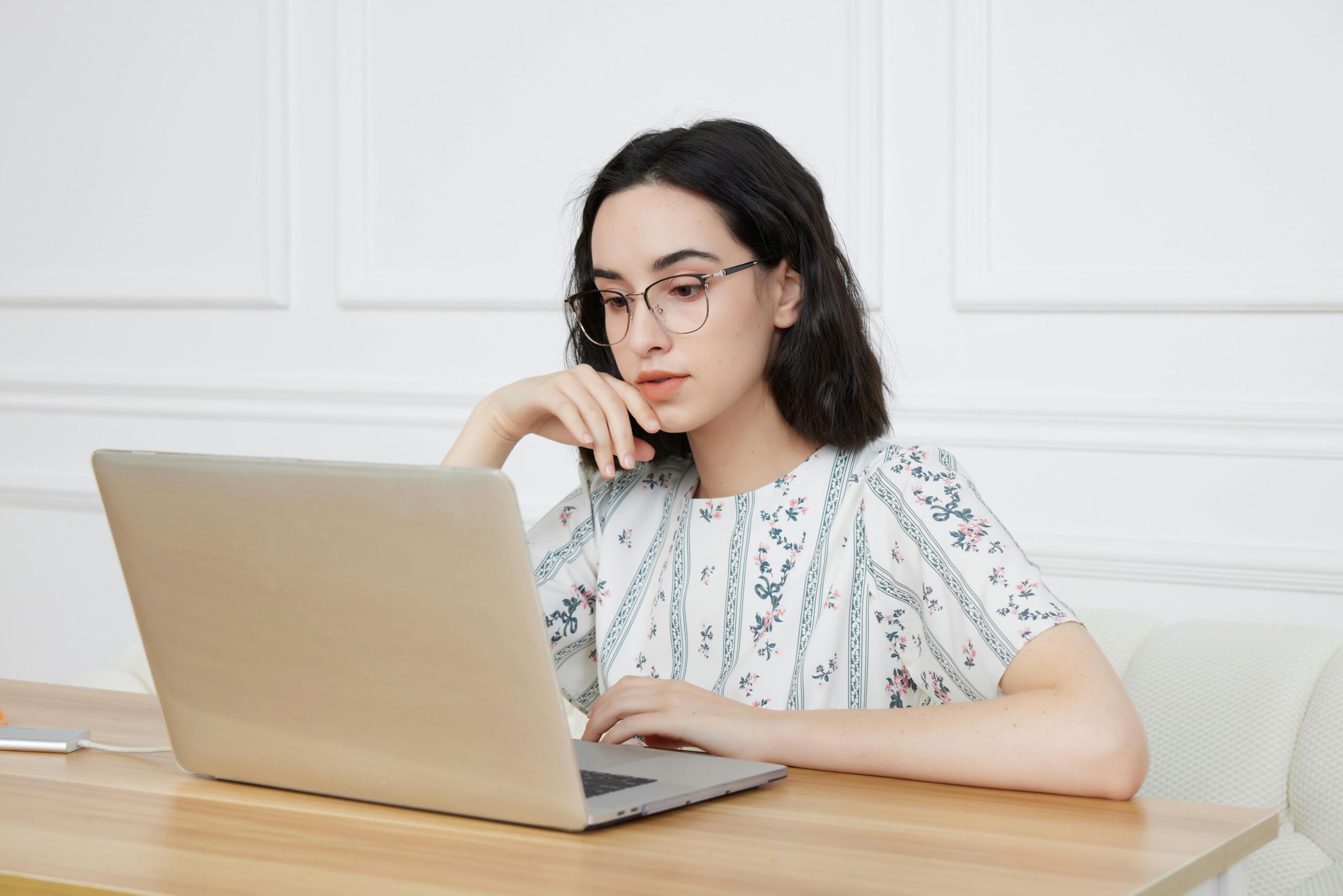 woman working at a laptop in a clean empty office