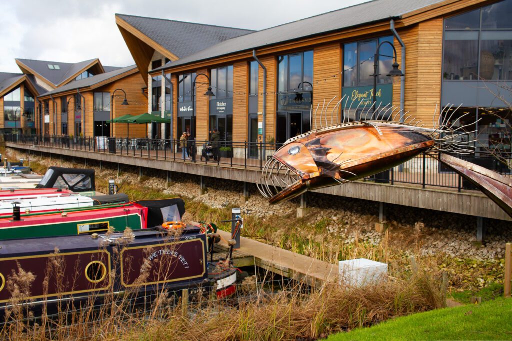 Exterior of the Derby office for Solutions for Accounting, with a decorative bronze fish statue in the foreground