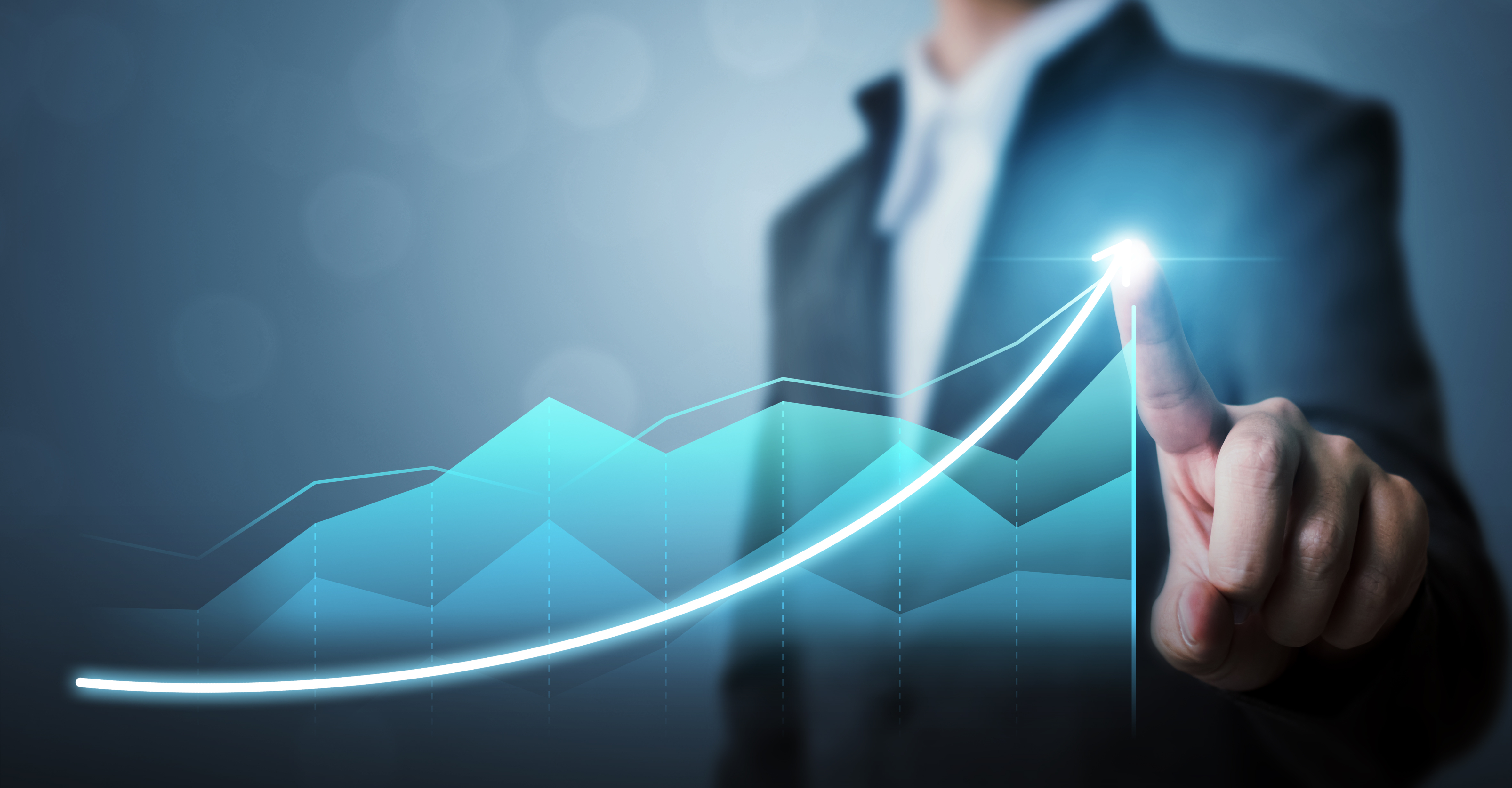 A man in business attire draws a holographic link graph with his finger. This could represent long-term growth.