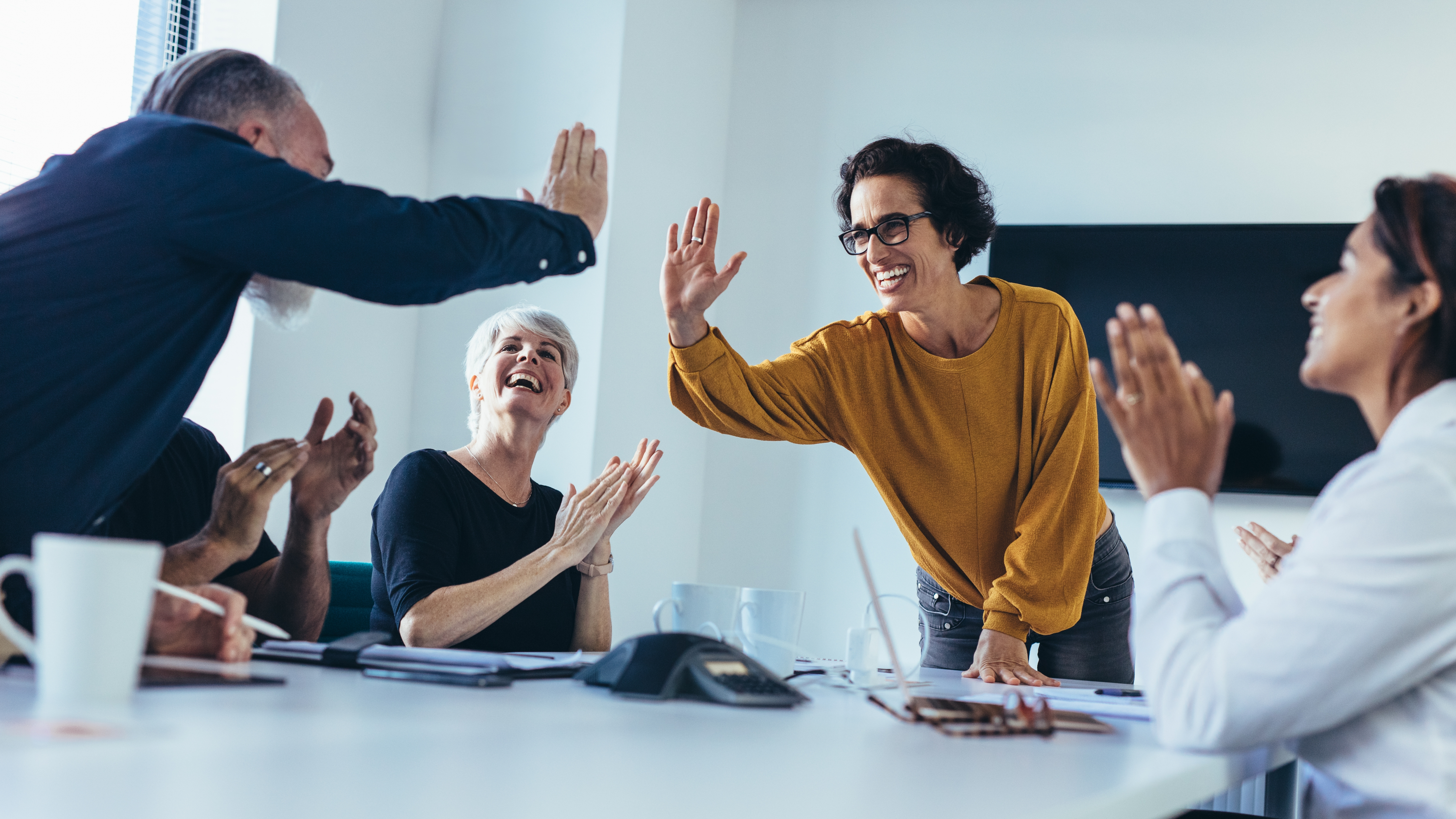 A group of colleagues celebrating their success at work.