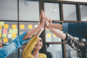 A group of coworkers high-fiving.