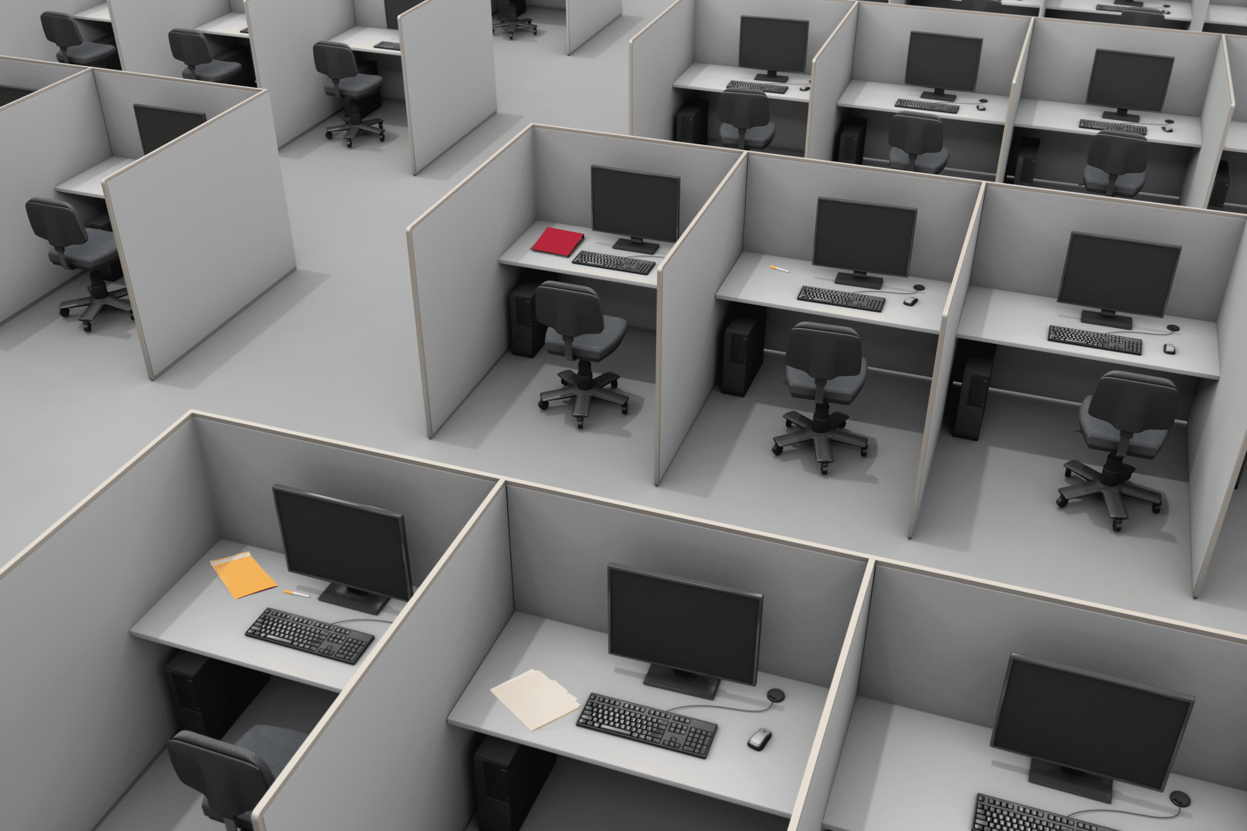 An elevated view of a bleak office space filled with tightly packed cubicles. Each cubicle is very narrow and contains a simple desk, computer, and desk chair.