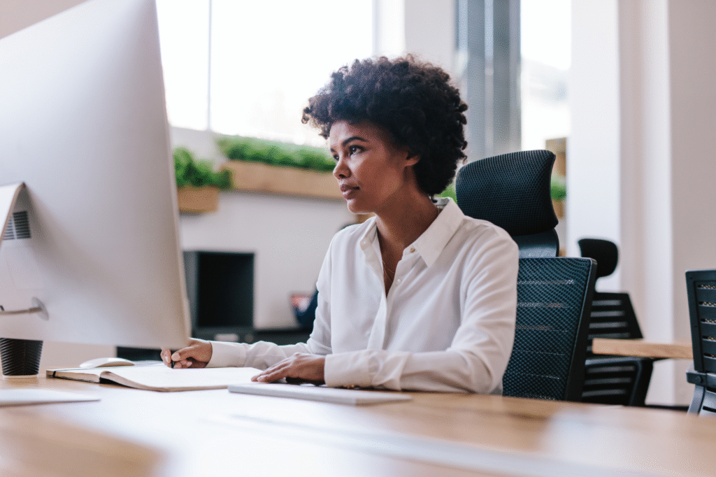 Black woman working at a computer in an office