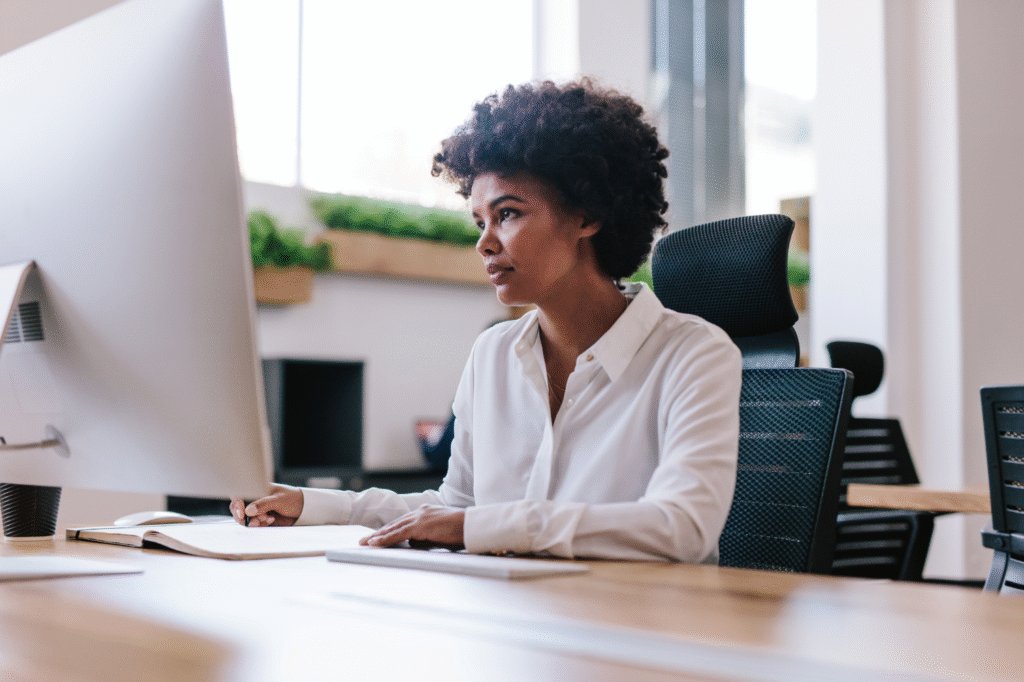 Black woman working at a computer in an office