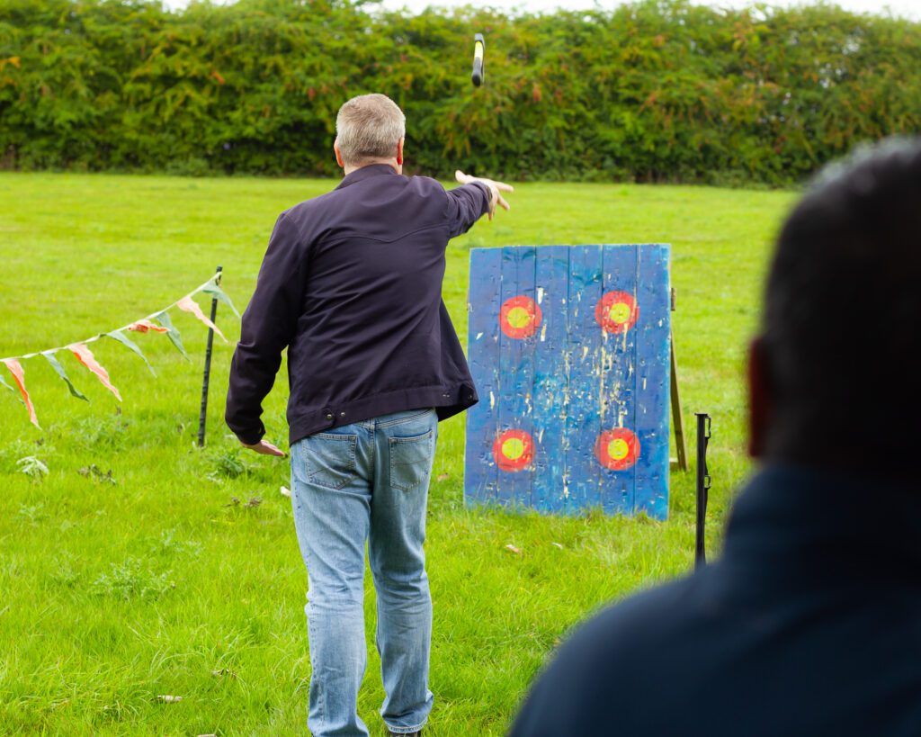 David Hollinshead doing axe throwing at the Solutions for Accounting Mystery Weekend Away 2025