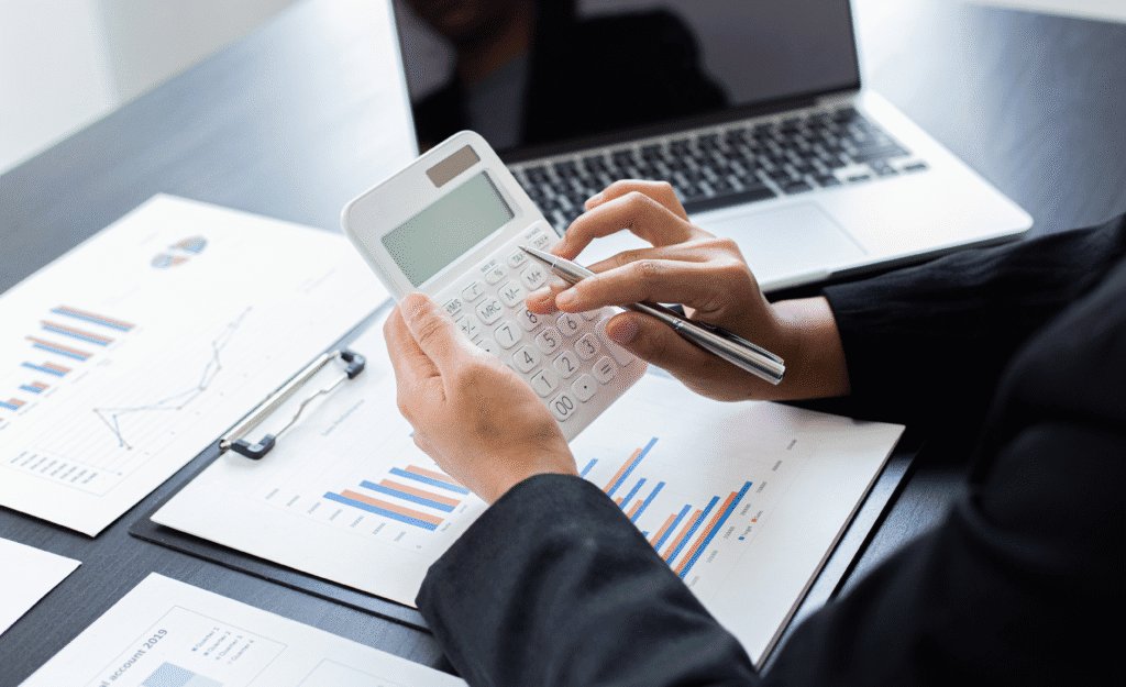 Close-up of an employee sitting at a desk, completing financial tasks.