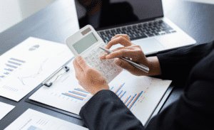An employee sat at a desk, working out VAT calculations.