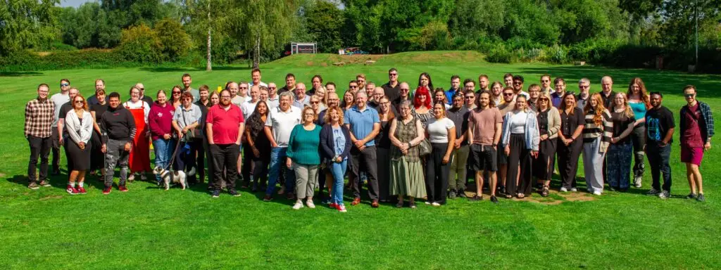 Cropped team photo of the Solutions for Accounting team on a field on a sunny summers' day