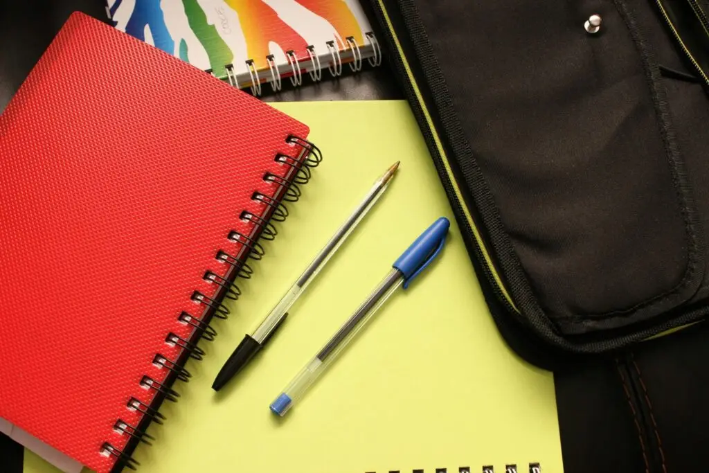 Closeup of some pens and folders on a school table