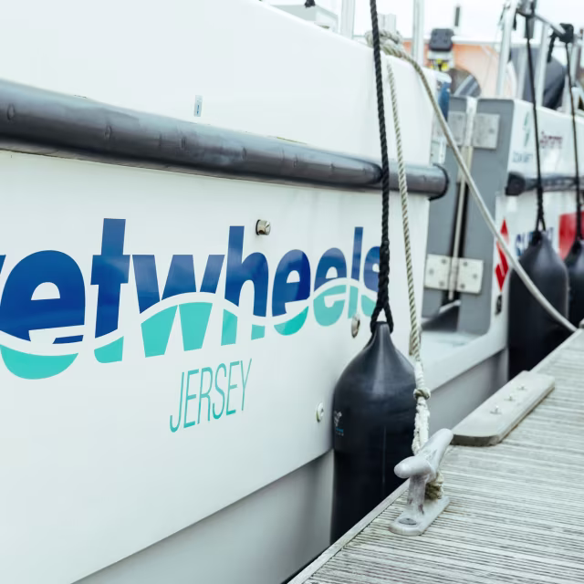 Closeup of the side of a boat with the Wetwheels logo
